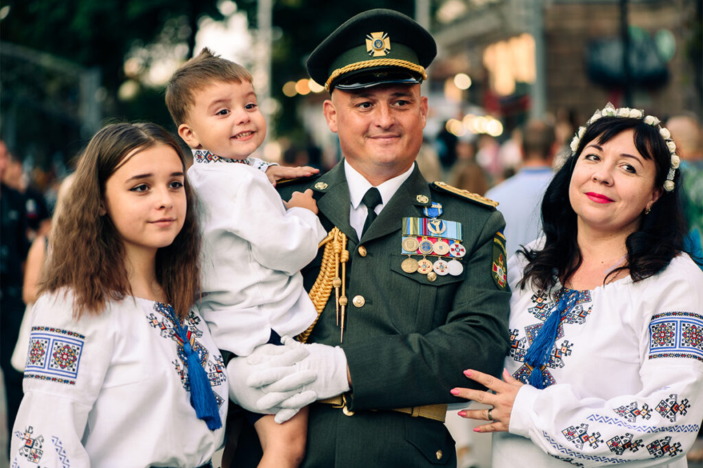 Officer in military dress uniform and family in national clothes, Ukrainian embroidered shirts the Independence Day of Ukraine